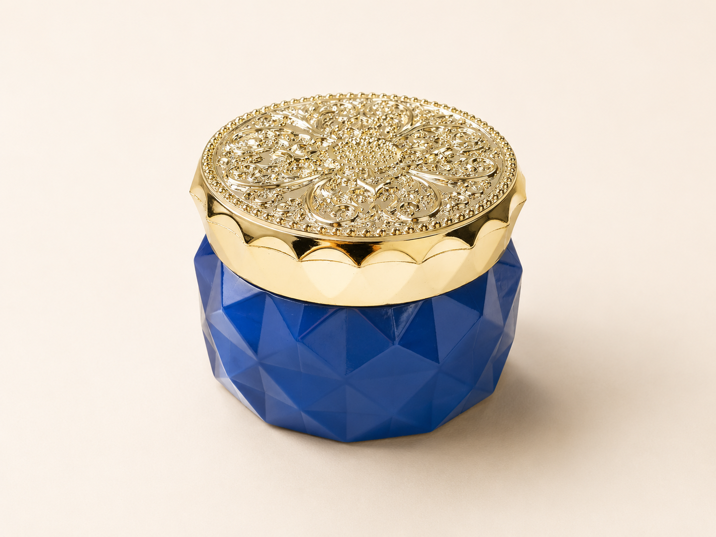 Decorative fruit jar with faceted blue body and ornate gold metallised lid